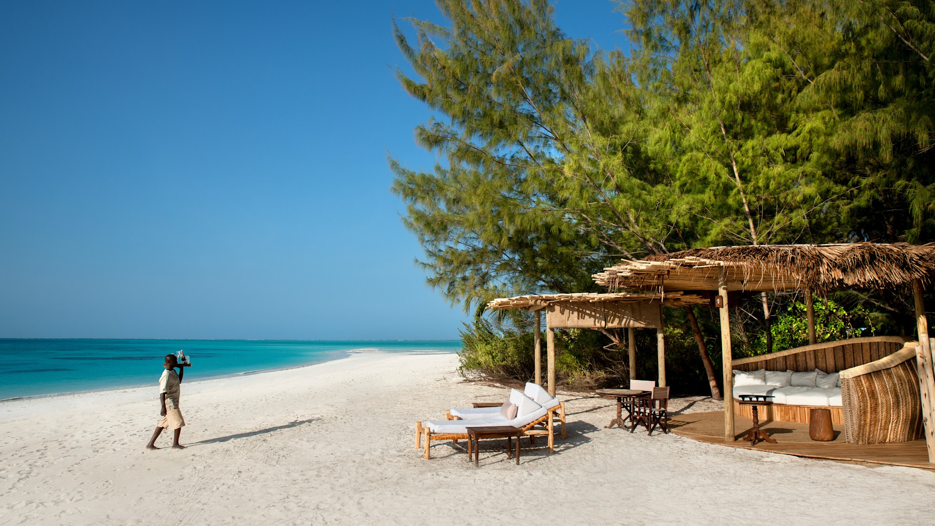 White sand, turquoise water and a beach lounge on Zanzibar