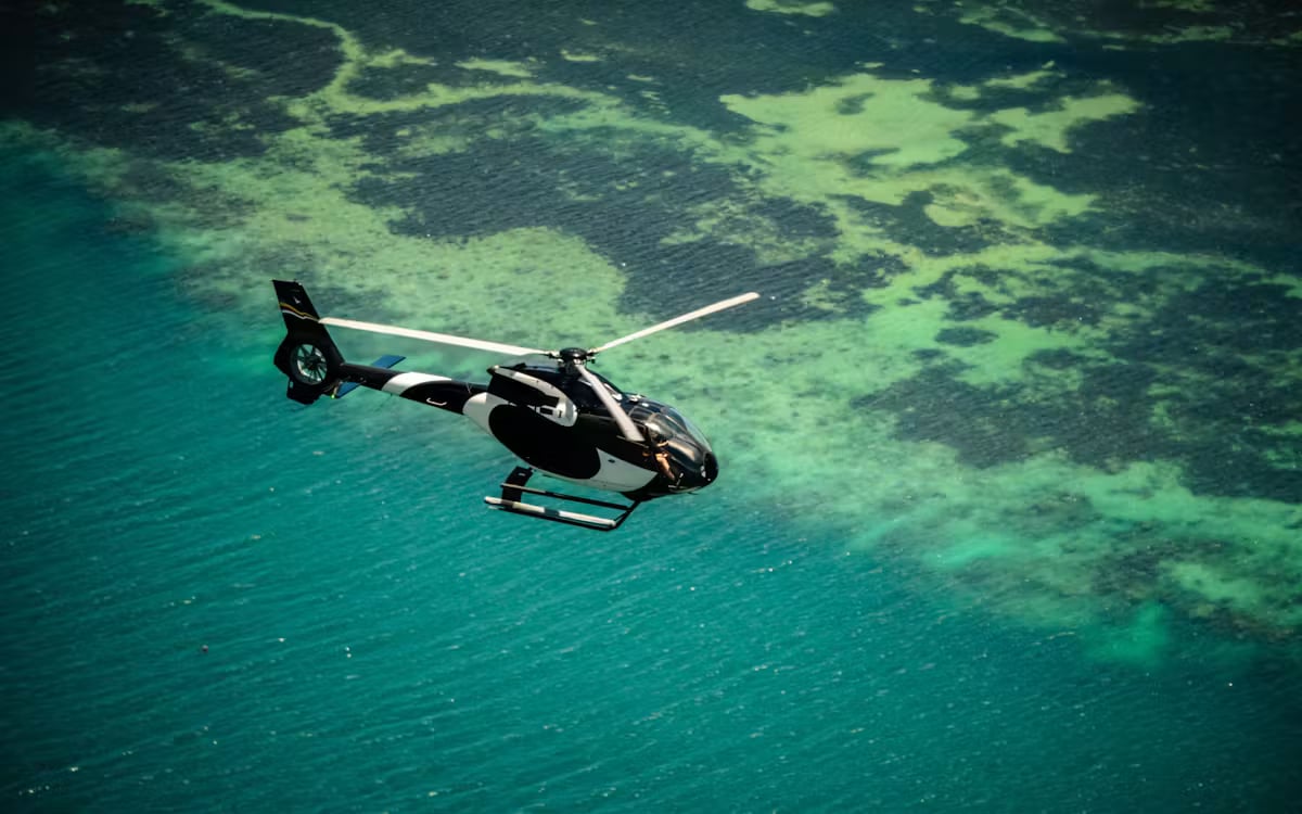 Mahé granite coast — catamaran and helicopter island-hopping