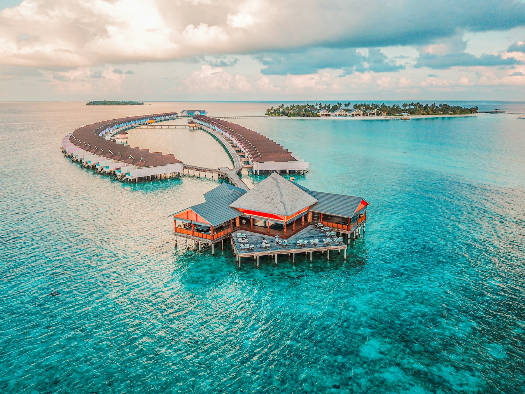 Aerial view of overwater villas on turquoise Indian Ocean water — an incentive photograph